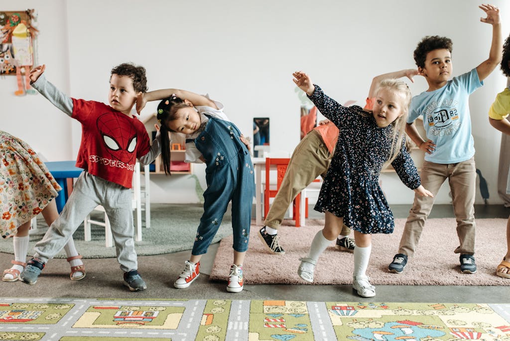 Group of diverse preschool children engaging in fun exercises indoors.